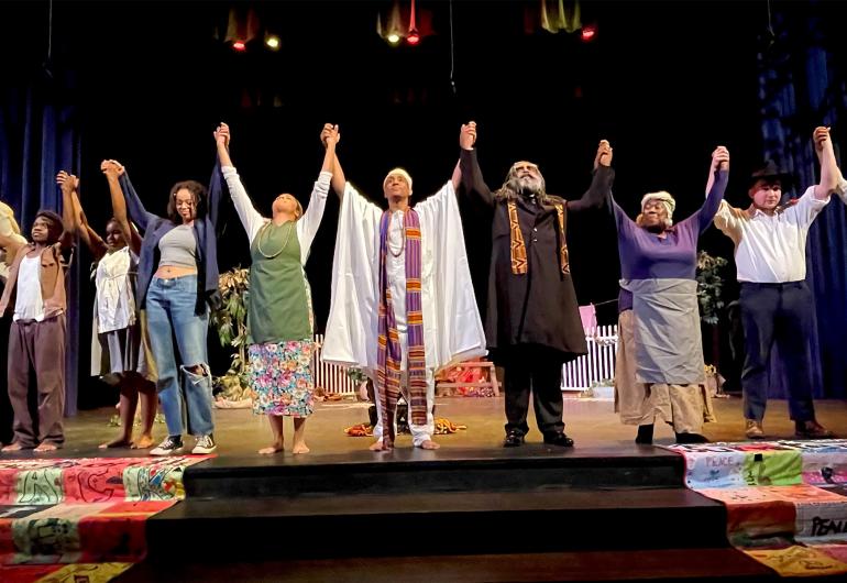 Cast of Kumbayah the Juneteenth Story holding hands raised before a bow