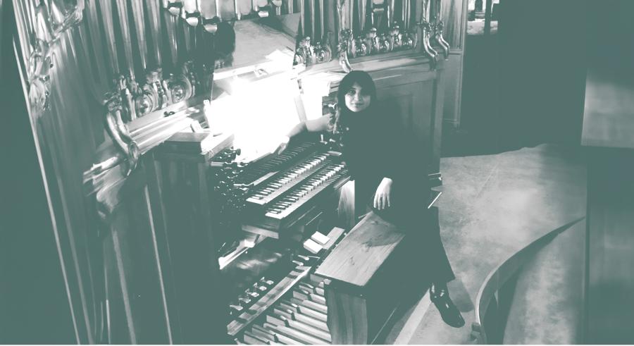 grayscale overhead view of Sarah at the organ