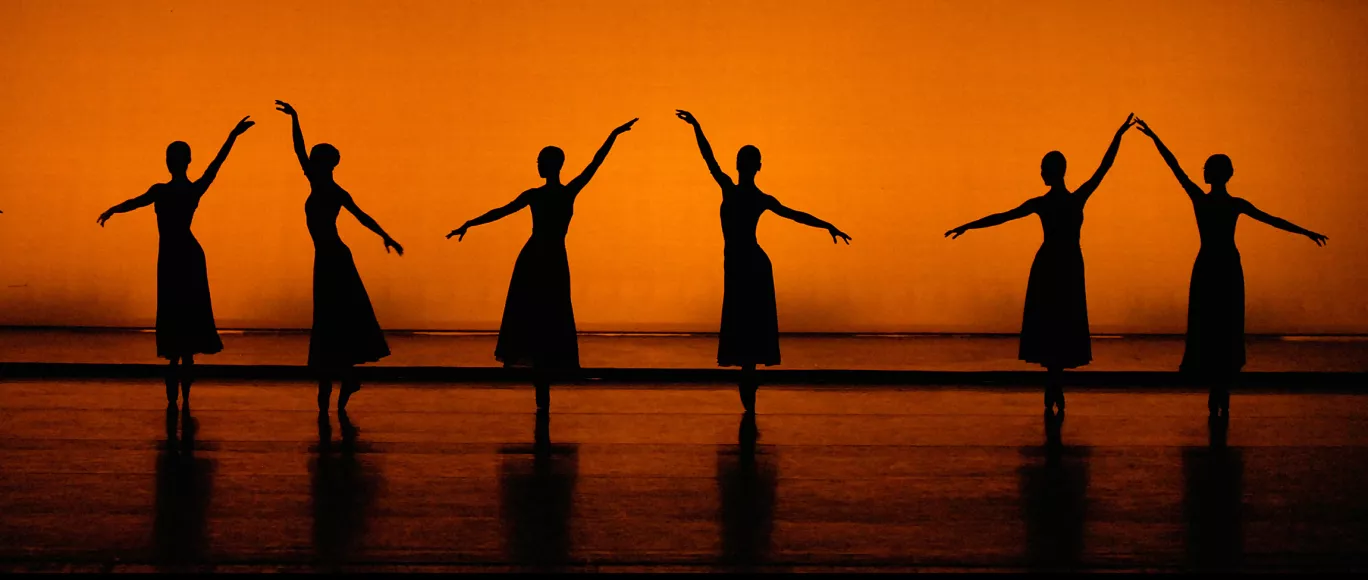 Sagalobeli - line of dancers in silhouette against a red-orange background