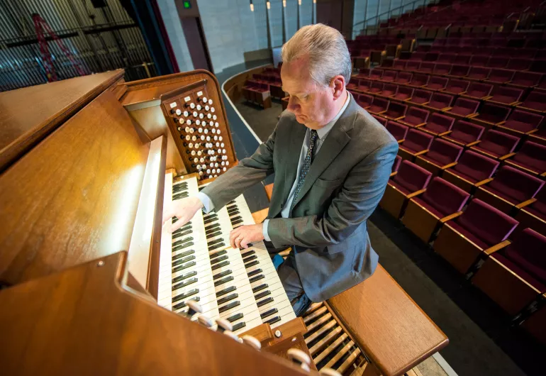 Dean Billmeyer playing the organ on the Northrop stage.