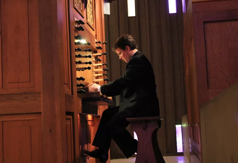 Profile of Paul playing the organ