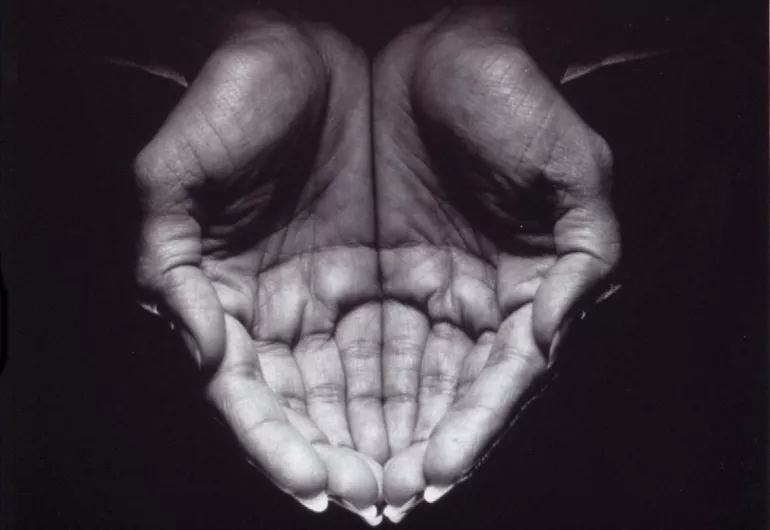 overhead close up of hands cupped tightly together