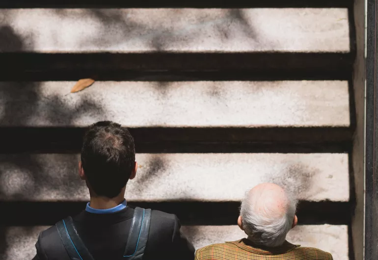 View from above of a young man and an elderly man walking