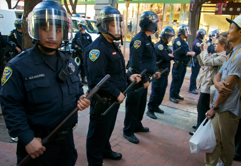 Line of police in riot gear