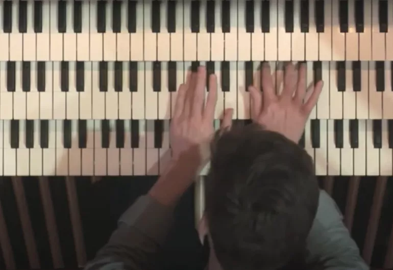 Overhead view of Zelek playing the keys of the organ