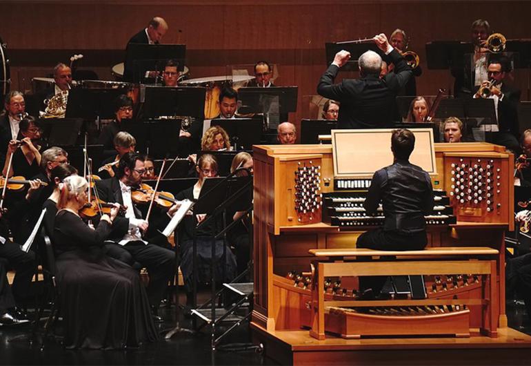 Zelek plays organ on stage with the Jacksonville Symphony