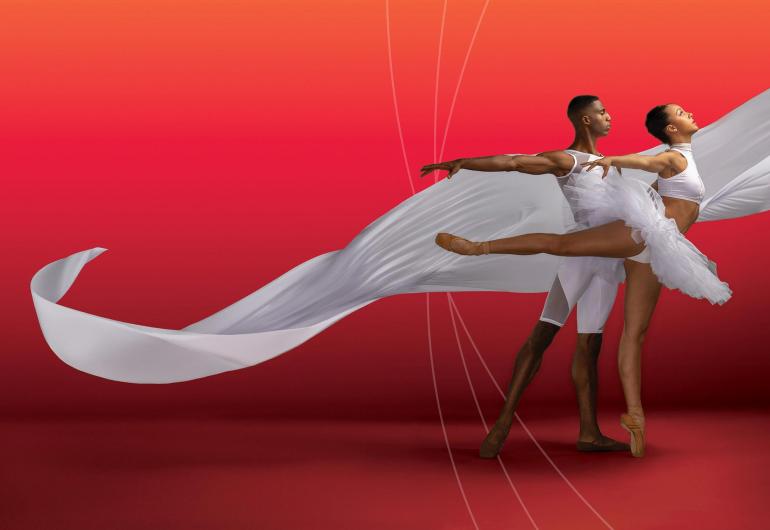Dance Theatre of Harlem pair in white with flowing white fabric next to them