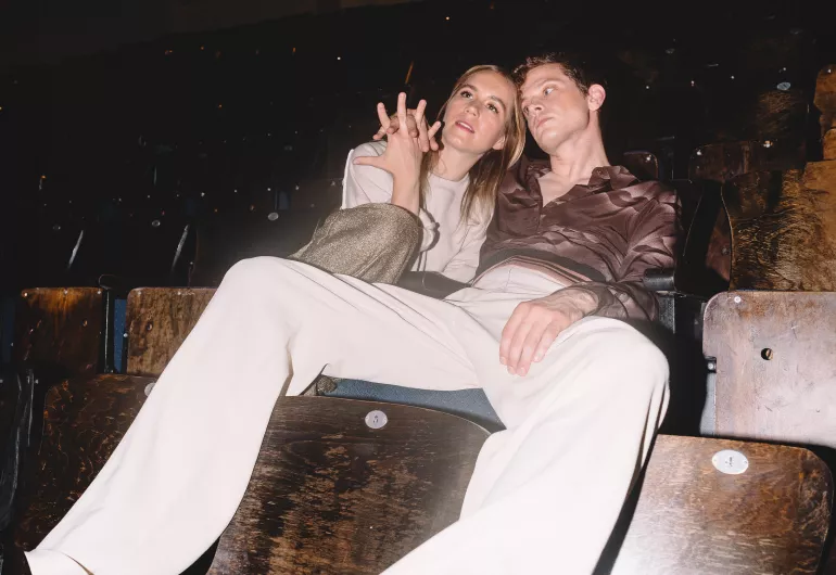 Kate Wallich holds hands with Perfume Genius in a theater