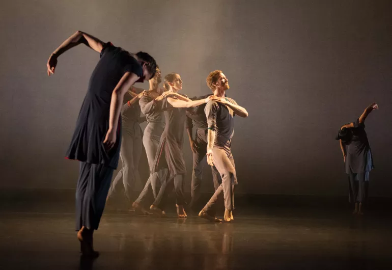 Dancers perform on a smoke filled stage