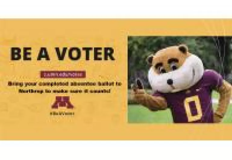 U of MN Mascot Goldie Gopher on the plaza in a football jersey giving the peace sign to the camera.  And Words on the left that say "Be A Voter"