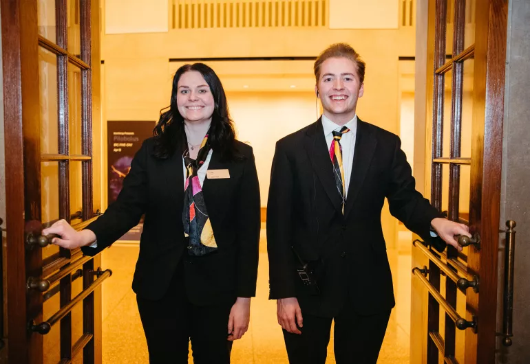 Student ushers opening Northrop's doors.