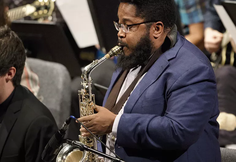 Christopher Rochester playing a saxaphone