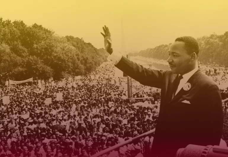 Historical image of Martin Luther King waving to a massive crowd outdoors