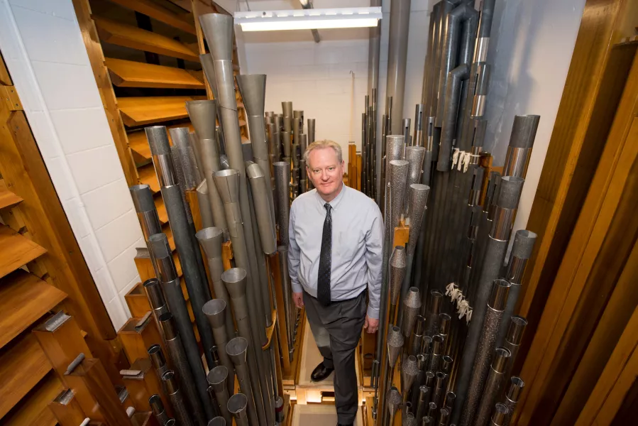 Dean Billmeyer stands among the pipes of the Northrop organ