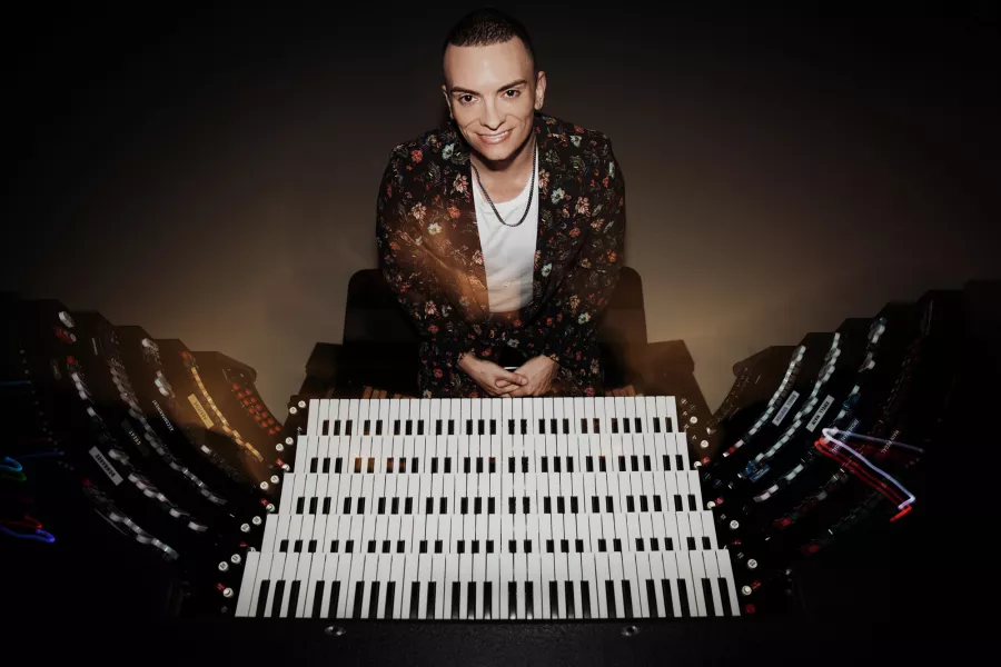 Cameron sitting at the organ with view of all the keys.