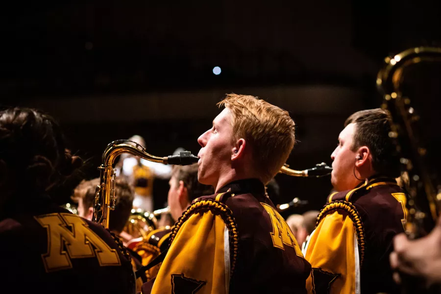 Marching band members performing.