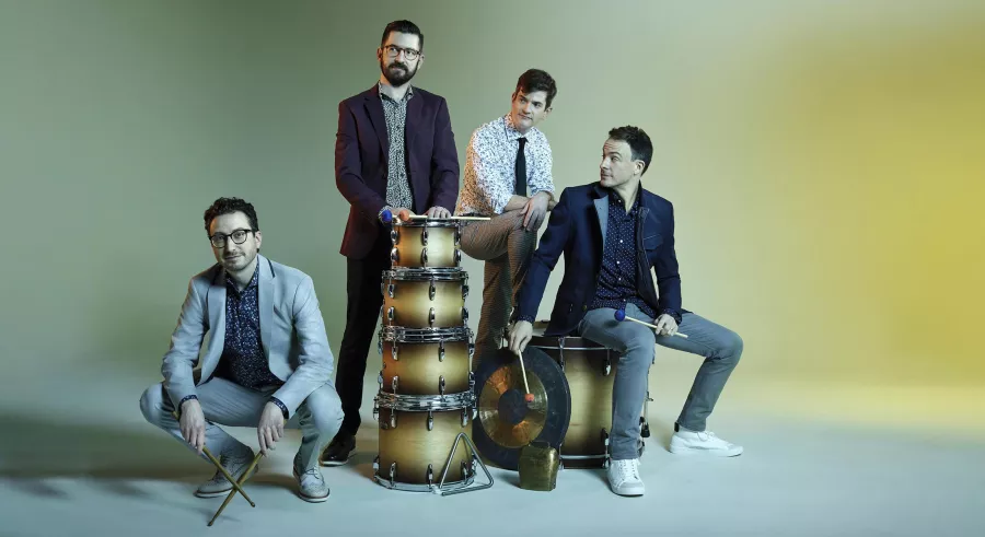 TCP members pose around a large stack of drums.