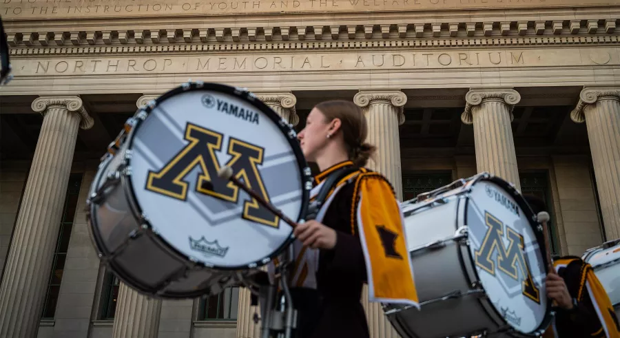 Drummers outside the Northrop building pillars.