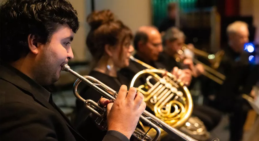 Close up of a row of brass players