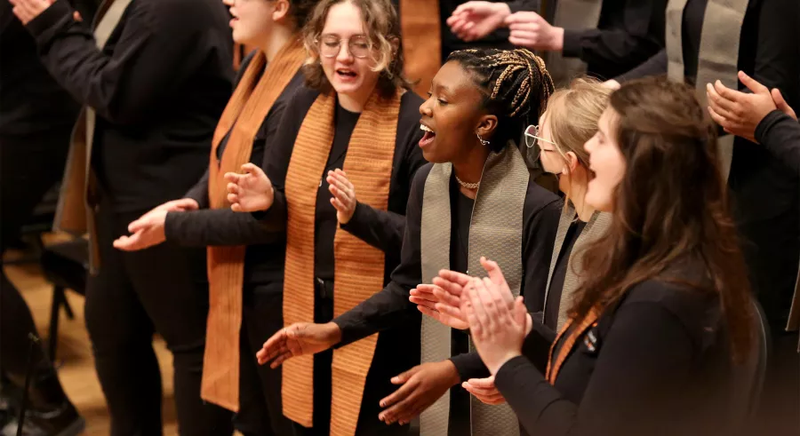 VocalEssence choral members laugh and sing.