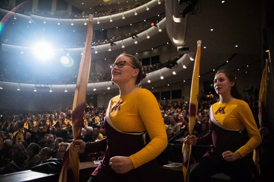 U of M Color Guard enters the stage from the audience