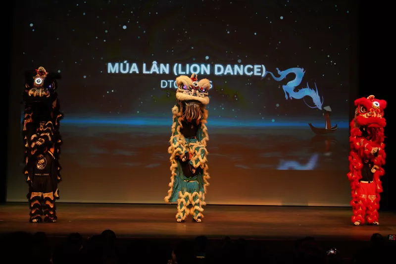 Three performers in traditional Vietnamese lion costumes