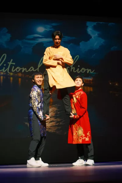 Three men model traditional fashions